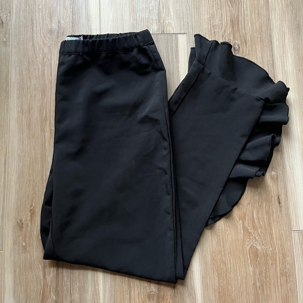 Lilly Edelman adorable black fitted pants with ruffled ankle detail.